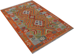 Handwoven Afghan Maimana kilim rug featuring a geometric pattern in orange, green, and blue tones.