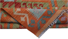 A handwoven Afghan Maimana kilim rug featuring geometric patterns in orange, green, and blue.