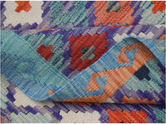 A handwoven Afghan Maimana kilim rug featuring a vibrant geometric pattern in wool.