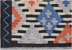 Handwoven Afghan Maimana kilim featuring a geometric pattern in blue, orange, and cream tones.