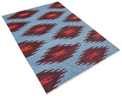Afghan Maimana Kilim with a blue background and repeating red and dark red diamond patterns.