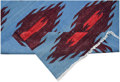 Handwoven Afghan Maimana kilim featuring a blue background with geometric maroon and red patterns.