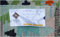 A handwoven Afghan Maimana Kilim featuring a colorful geometric pattern on a flat wool weave.