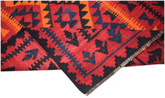 A handmade Afghan Maimana kilim featuring a geometric pattern in red, black, and orange wool.