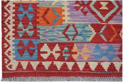 Handwoven Afghan Maimana kilim rug featuring a vibrant geometric pattern in wool.