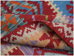 A handmade Afghan Maimana kilim rug featuring a vibrant geometric pattern in wool.