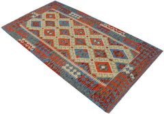 Handwoven Afghan Maimana kilim rug featuring a geometric diamond pattern in red, blue, and green.