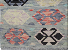 Handwoven Afghan Maimana kilim rug featuring a light blue background with geometric hexagon motifs.