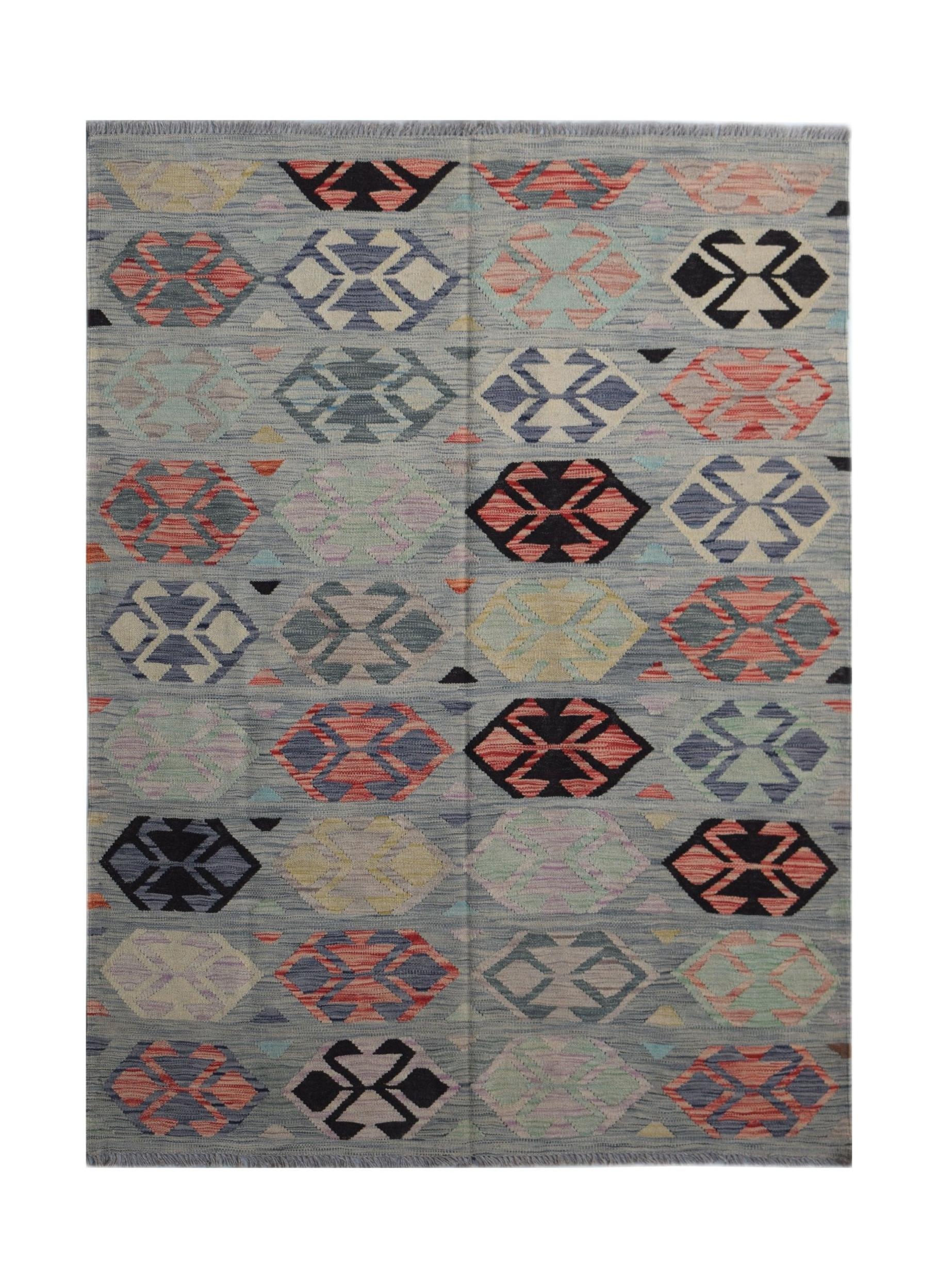 Handwoven Afghan Maimana kilim rug featuring a repeating geometric pattern in multicolored wool.
