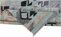 A handwoven Afghan Maimana kilim rug featuring geometric patterns in blue and neutral tones.