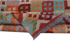 A handmade Afghan Maimana kilim rug featuring a colorful geometric pattern and fringed edges.