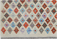 Handmade Afghan Maimana kilim rug featuring a repeating geometric pattern in vibrant colors.