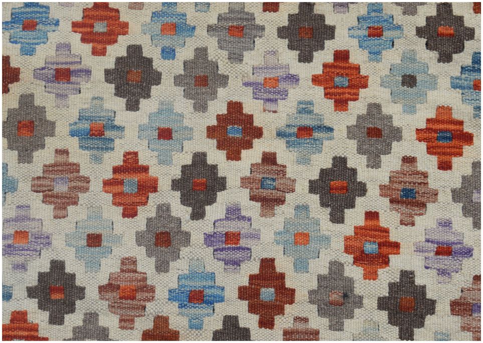 Handmade Afghan Maimana kilim rug featuring a repeating geometric pattern in vibrant colors.
