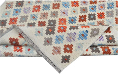 Handmade Afghan Maimana kilim rug featuring a geometric pattern in orange, blue, and grey.