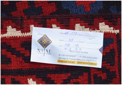 A handwoven Afghan Maimana Kilim featuring a geometric pattern in red, blue, and cream wool.