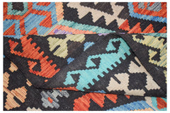 A handmade Afghan Maimana kilim featuring a geometric pattern in vibrant wool colors.