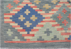 Handwoven Afghan Maimana kilim rug featuring a geometric diamond pattern in blue, red, and cream.
