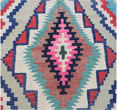 Handwoven Afghan Maimana kilim featuring a geometric diamond pattern in vibrant wool colors.