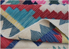 A handwoven Afghan Maimana kilim rug featuring a colorful geometric pattern on a cream background.