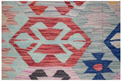 Handwoven Afghan Maimana kilim featuring a geometric pattern in vibrant red, blue, and light tones.
