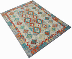 Handwoven Afghan Maimana kilim rug featuring a geometric pattern in orange, blue, and yellow.