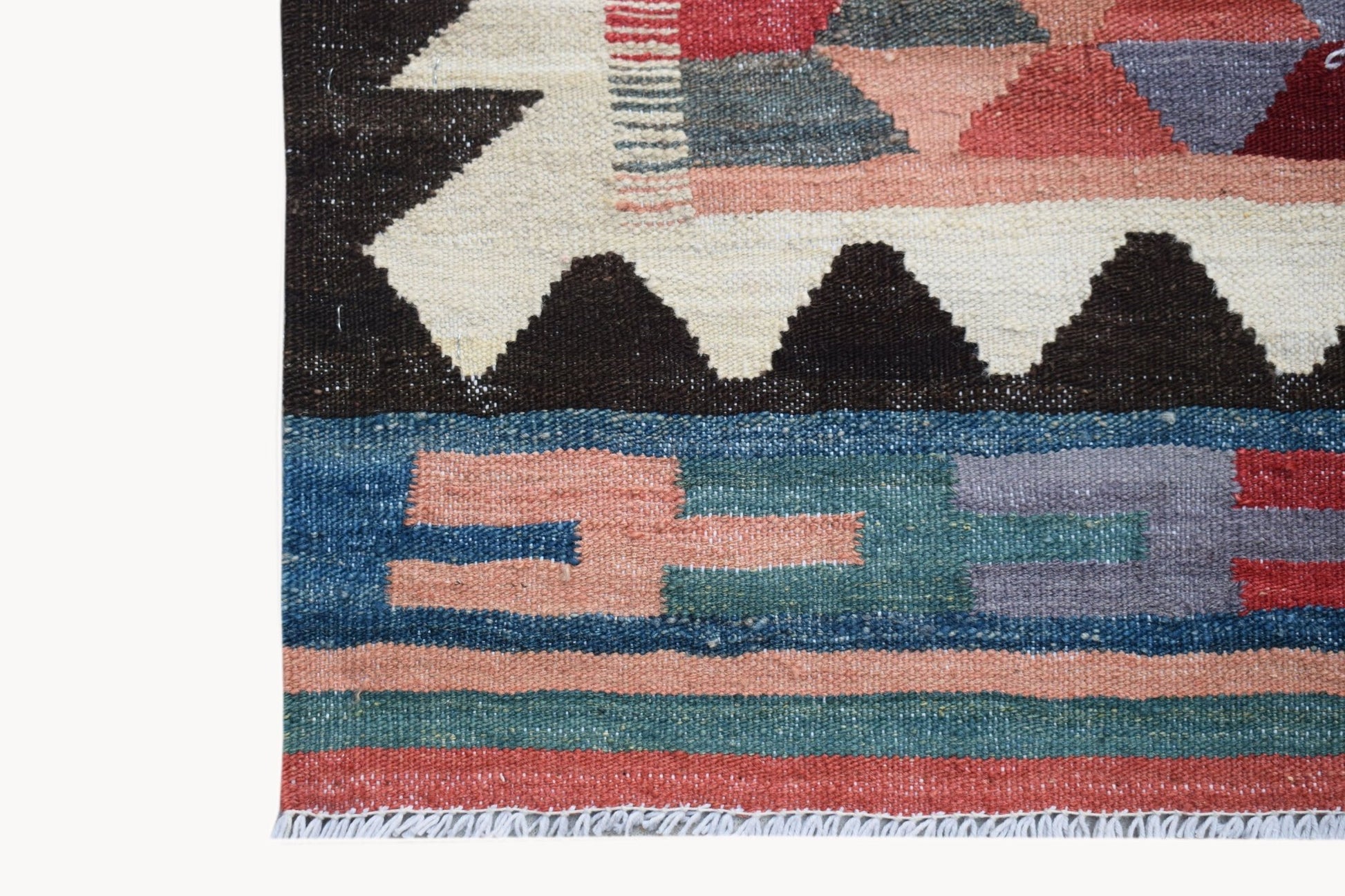 Handwoven Afghan Maimana kilim featuring geometric patterns in red, blue, and cream wool.