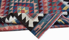 Handwoven Afghan Maimana kilim featuring a geometric pattern in vibrant multicolored wool.