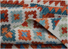 A handmade Afghan Maimana kilim rug featuring a geometric pattern in orange, blue, and green.