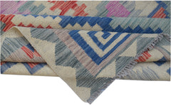 Handwoven Afghan Maimana kilim rug featuring a geometric pattern in blue, red, and neutral tones.