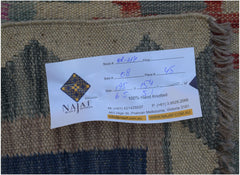 A handwoven Afghan Maimana kilim featuring a geometric pattern in earthy tones.