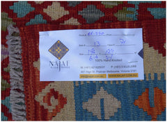 A handwoven Afghan Maimana kilim featuring a geometric pattern in red, blue, and beige tones.