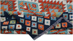 A handmade Afghan Maimana kilim rug featuring geometric patterns in blue, orange, and cream.