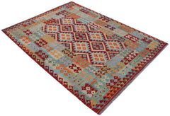 Handwoven Afghan Maimana kilim rug featuring a geometric pattern in red, orange, and blue tones.