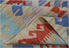 A handwoven Afghan Maimana kilim rug featuring a geometric pattern in vibrant wool colors.