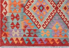 Handwoven Afghan Maimana kilim rug featuring a vibrant geometric pattern in wool.