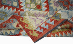Handwoven Afghan Maimana kilim rug featuring a geometric pattern in red, blue, and yellow tones.