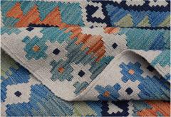 A handmade Afghan Maimana kilim rug featuring a geometric pattern in blue, orange, and cream wool.