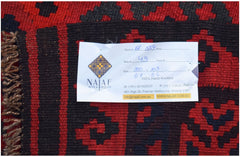 A handwoven Afghan Maimana kilim featuring a geometric pattern in red and black wool.