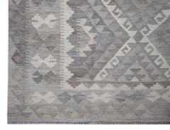 Handwoven Afghan Maimana kilim rug featuring a geometric pattern in shades of grey and cream.