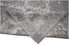 A handwoven Afghan Maimana kilim rug featuring a grey and white geometric pattern.
