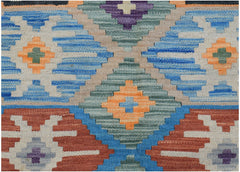 Handwoven Afghan Maimana kilim featuring a geometric pattern in blue, orange, and earthy tones.