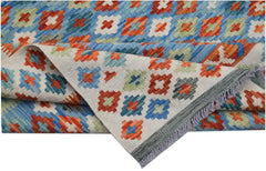 A handmade Afghan Maimana kilim rug featuring a colorful geometric pattern on a flatweave wool base.