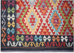 Handwoven Afghan Maimana kilim featuring a vibrant geometric pattern in a flatweave wool texture.