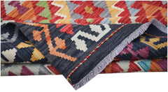 A handwoven Afghan Maimana kilim featuring a vibrant geometric pattern and flatweave texture.