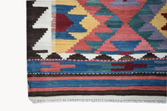 Handwoven Afghan Maimana kilim featuring a geometric pattern in vibrant multicolored wool.