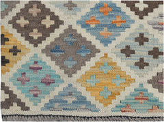 Handmade Afghan Maimana kilim rug featuring a colorful geometric diamond pattern on a cream base.