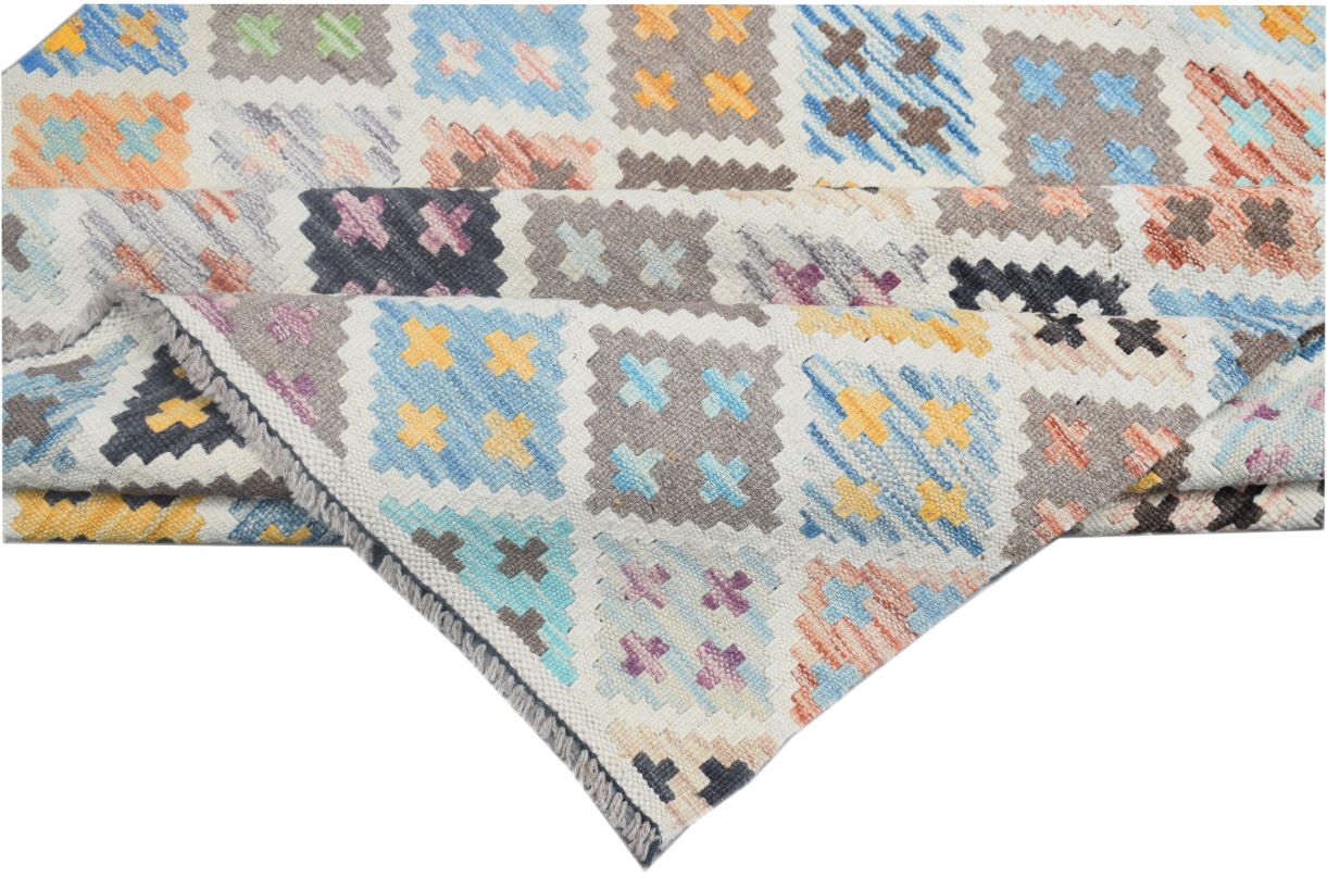 Handmade Afghan Maimana kilim rug featuring a colorful geometric pattern of small crosses.