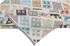 Handmade Afghan Maimana kilim rug featuring a colorful geometric pattern of small crosses.