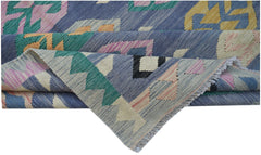 A handmade Afghan Maimana kilim featuring a geometric pattern in blue, pink, green, and yellow.