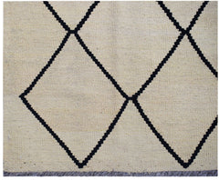 Handwoven Afghan Maimana kilim rug featuring a black geometric diamond pattern on a cream background.